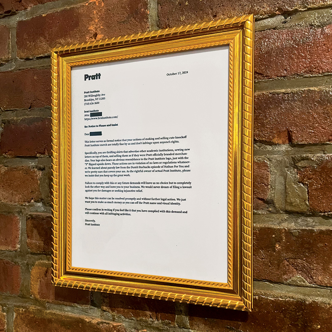 framed please & insist hanging on wall
